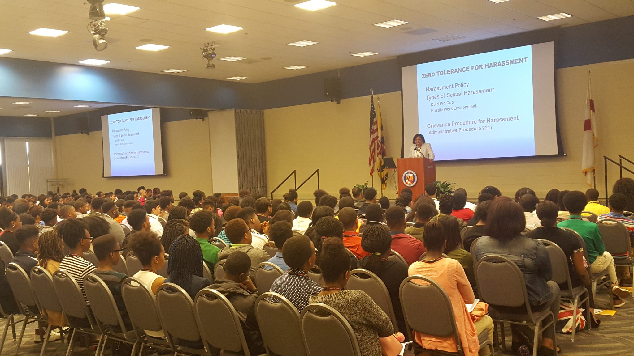 Debra Arrington (at podium) of the Prince George's County Office of Human Resources Management's employee and labor division explains the guidelines for the county's "Youth@Work" summer-jobs program during an orientation at Prince George's Community College in Largo on June 23. (William J. Ford/The Washington Informer)
