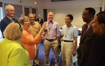 Prince George's County Economic Development Corporation President and CEO Jim Coleman (second from right) speaks with scientists from the Beltsville Agricultural Research Center during the Maryland Agricultural Roundtable in Beltsville on Sept. 9. (Courtesy photo)