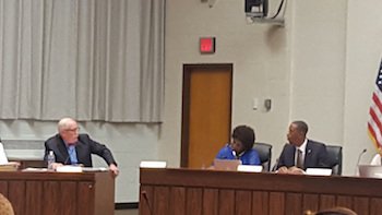 Prince George's County Public Schools CEO Kevin Maxwell (left) discusses some of the training employees have received during a school board meeting in Upper Marlboro on Sept. 8. Photo by William J. Ford