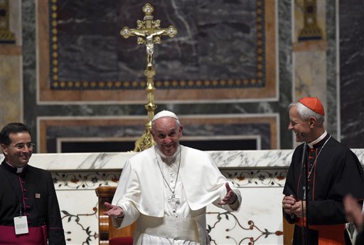 Pope Francis, center, standing with Cardinal Donald Wuerl, archbishop of Washington, right, expresses his disappointment that he can't stay longer to greet everyone following the midday prayer from the Liturgy of Hours, the daily form of prayer of the Catholic Church, with bishops from the U.S., Wednesday, Sept. 23, 2015, at the Cathedral of St. Matthew the Apostle in Washington. (AP Photo/Susan Walsh)