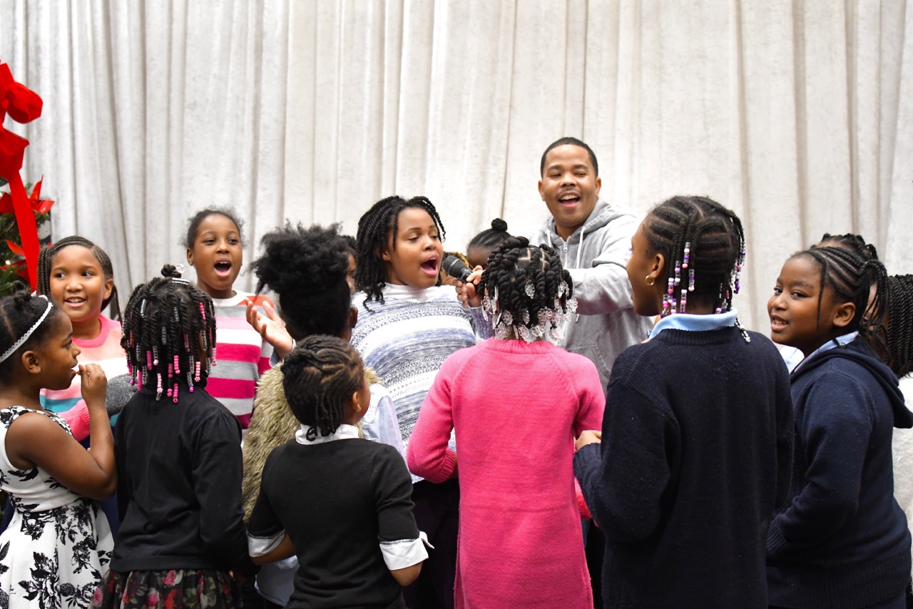 Hundreds of Ward 8 residents participate in the Cozy Christmas at Gateway toy giveaway sponsored by the Events DC and The Washington Informer Charities on Dec. 15. (Travis Riddick)