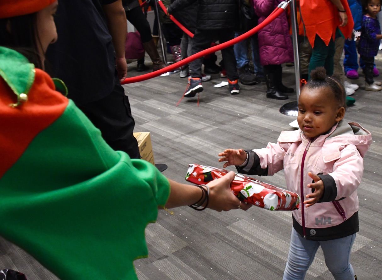 Hundreds of Ward 8 residents participate in the Cozy Christmas at Gateway toy giveaway sponsored by the Events DC and The Washington Informer Charities on Dec. 15. (Travis Riddick)