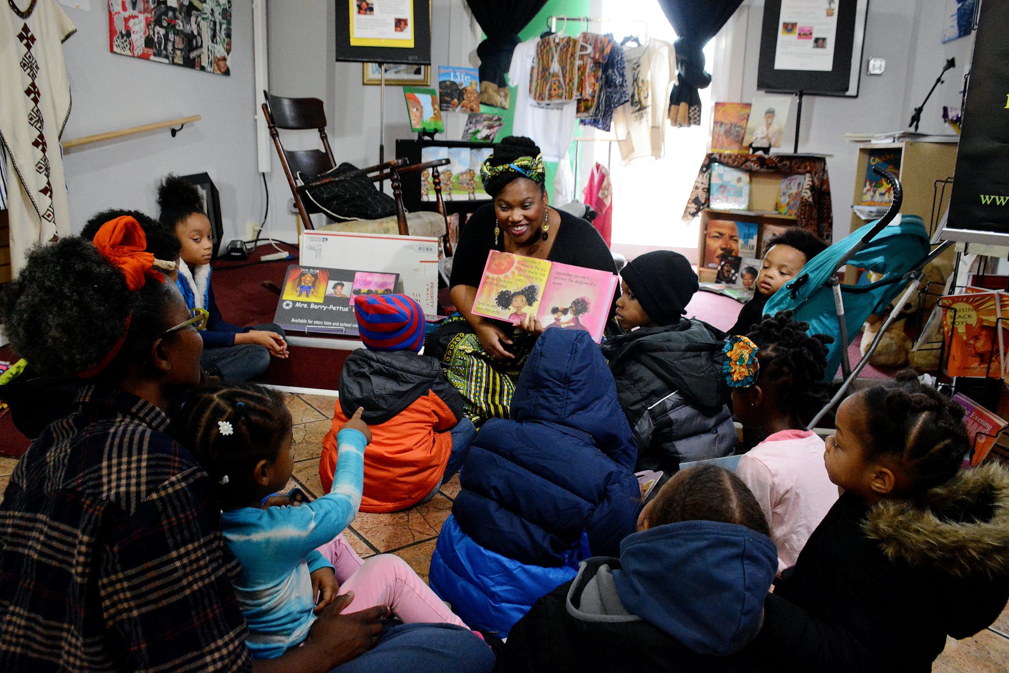 Children's books author Sherrita Berry-Petus reads to children attending the Magical-Mirrors book fair at Sankofa Video Books & Cafe in Northwest on Sunday, Dec. 11.