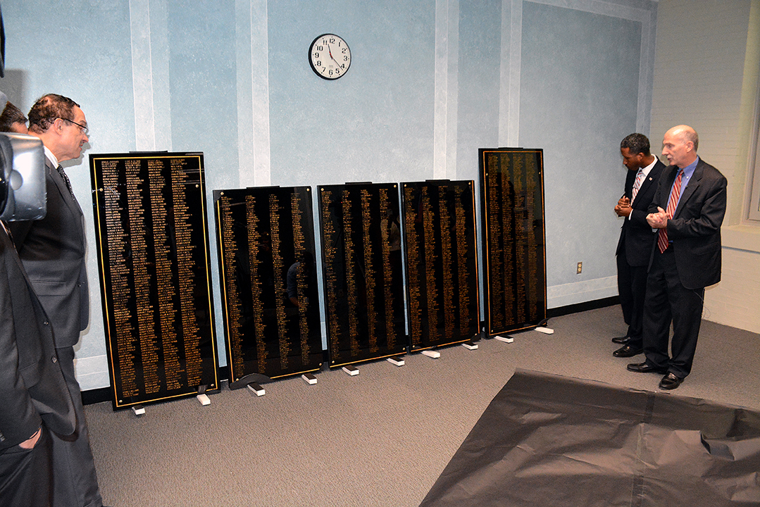 D.C. Council members Phil Mendelson and Kenyan McDuffie and Councilman-elect Vincent Gray rededicate a historic World War II Memorial to the nearly 1,900 city government employees who served during World War II on Friday, Nov. 11 at the John A. Wilson Building in Northwest. /Photo by Roy Lewis
