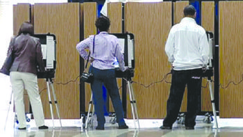 Prince George's County voters use touch-screen machines to cast votes at a precinct at Woodmore Elementary School in Mitchellville, Maryland, during the Nov. 4 general election. William J. Ford