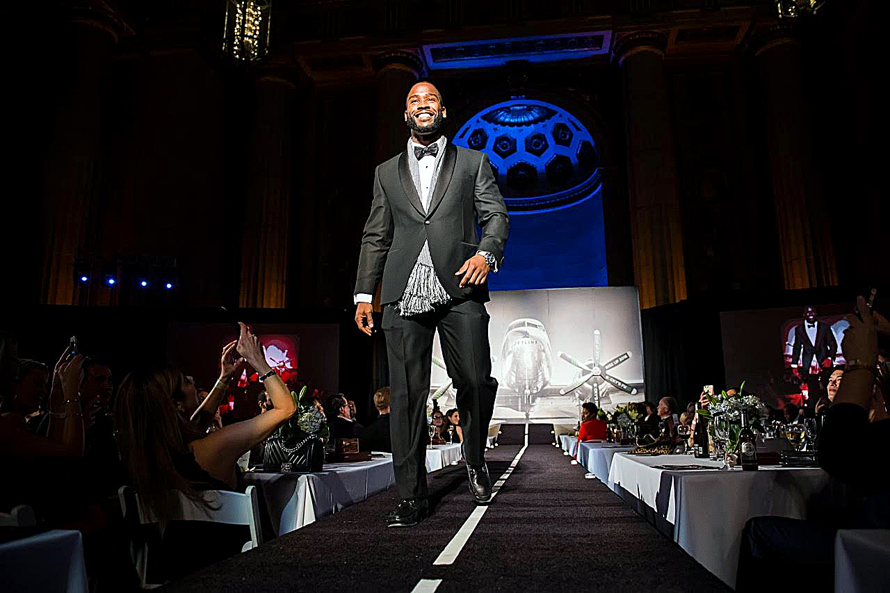 Athletes took to the runway in a fashion show fundraiser for local programs that support and assist victims of domestic violence.