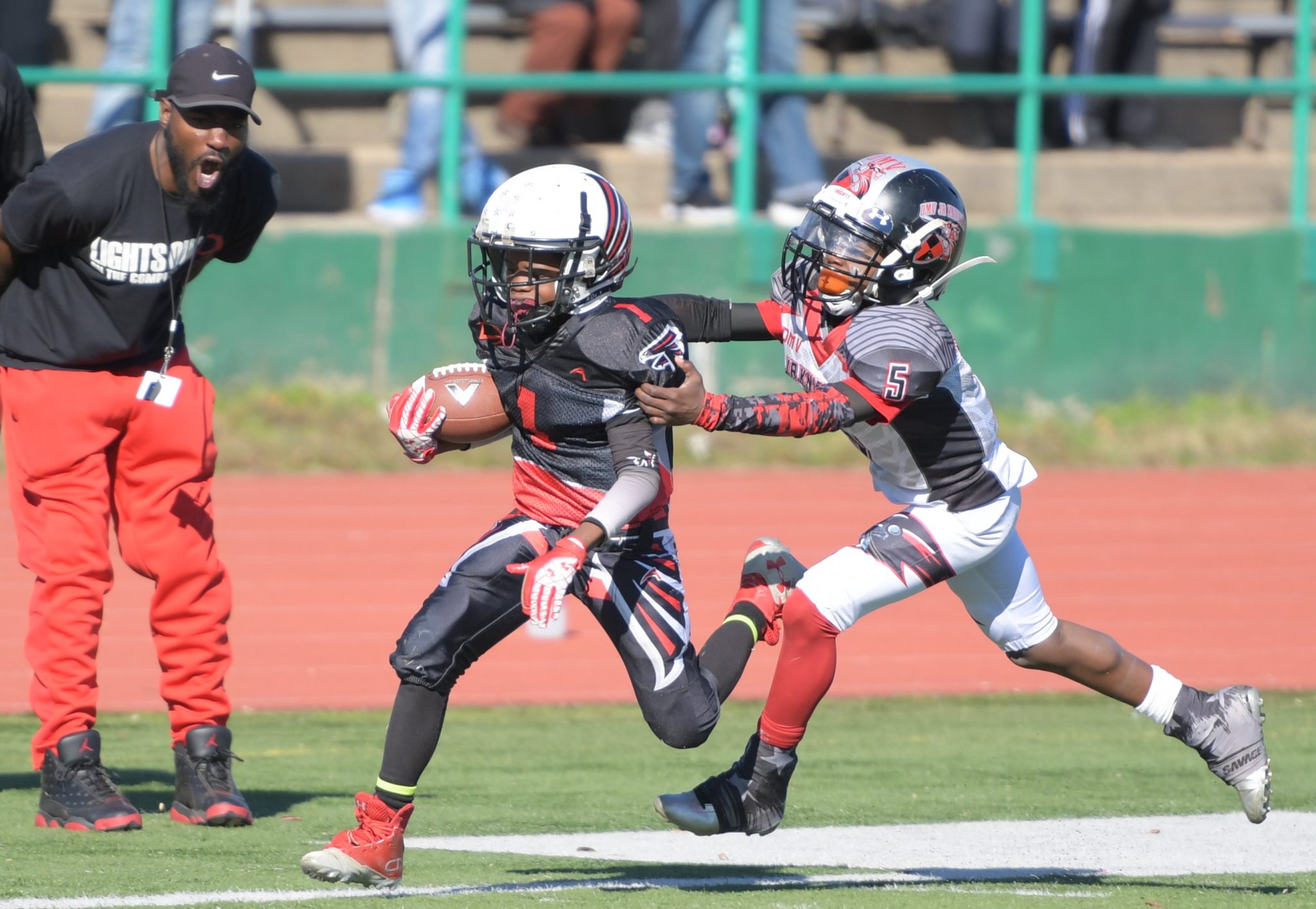 The DMV Jr. Knights (in white) and Forestville Falcons face off in the championship game for the 10U division of American Youth Football's Capital Beltway League at Spingarn High School Field in northeast D.C. on Saturday, Nov. 5. /Photo by John E. De Freitas