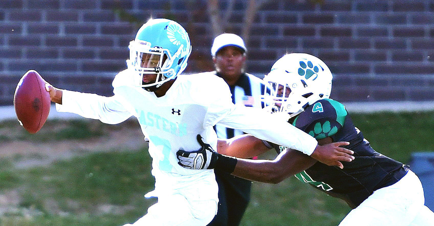 Eastern Ramblers quarterback Jerome Johnson is tackled by Woodrow Wilson Tigers linebacker Anton Reed during the Tigers' 50-0 homecoming win at Woodrow Wilson High School's Tiger Stadium in northwest D.C. on Saturday, Oct. 29. /Photo by John E. De Freitas