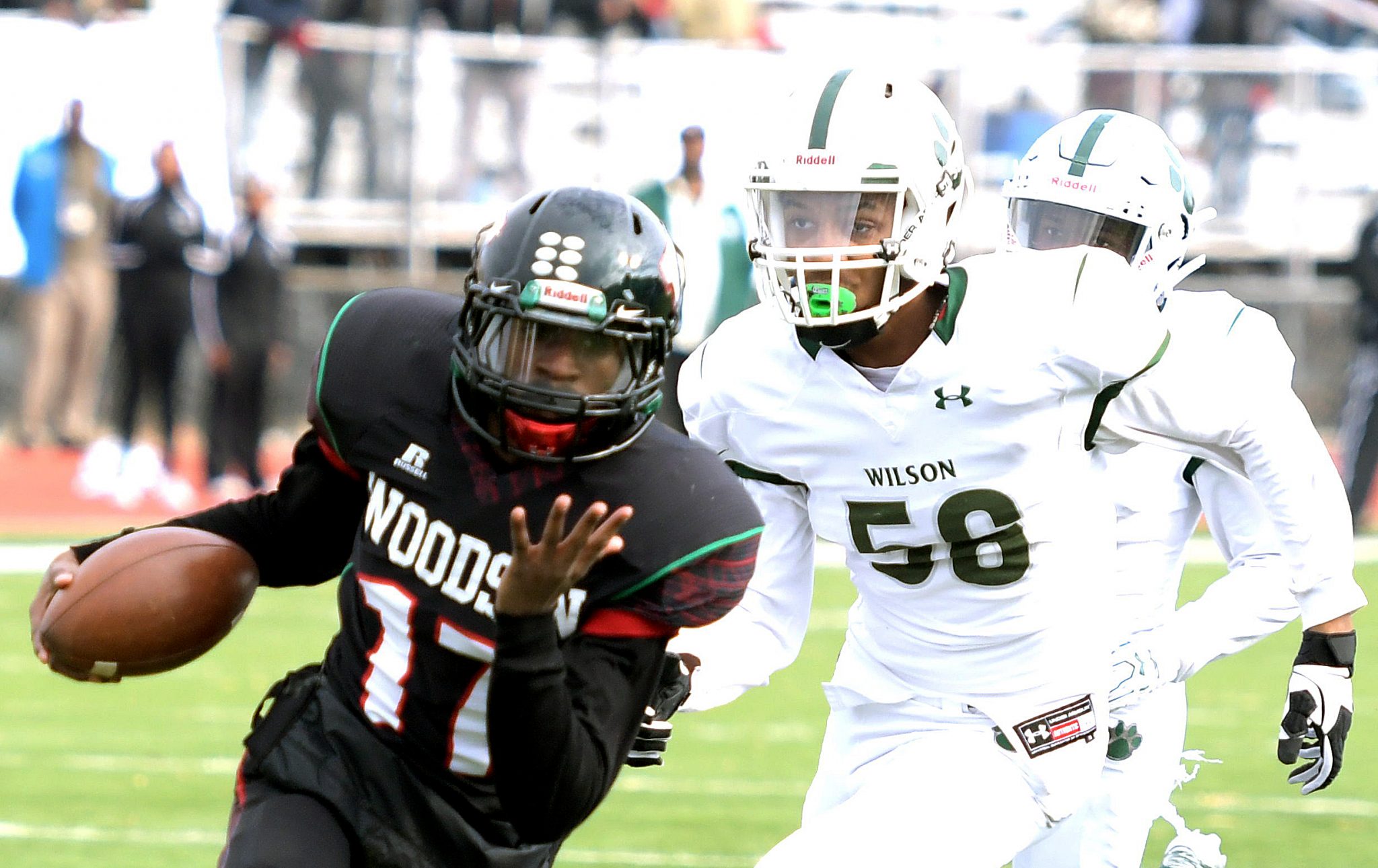 H.D. Woodson quarterback Tyron Robinson runs past Wilson High School defensive back Nicolas Allen for a first-quarter touchdown during Woodson's 22-20 win in the 47th annual DCIAA Turkey Bowl Football championship game at Eastern High School in northeast D.C on Thursday, Nov. 24. /Photo by John E. De Freitas