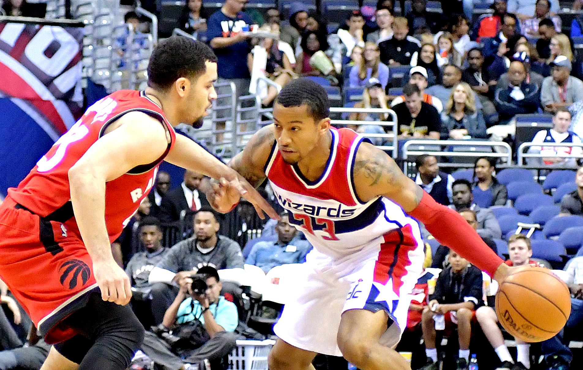 Washington Wizards guard Trey Burke faces off against Toronto Raptors guard Fred VanVleet during the Wizards' 119-82 home win in both teams' final preseason game on Friday, Oct. 21 at the Verizon Center in northwest D.C. /Photo by John E. De Freitas