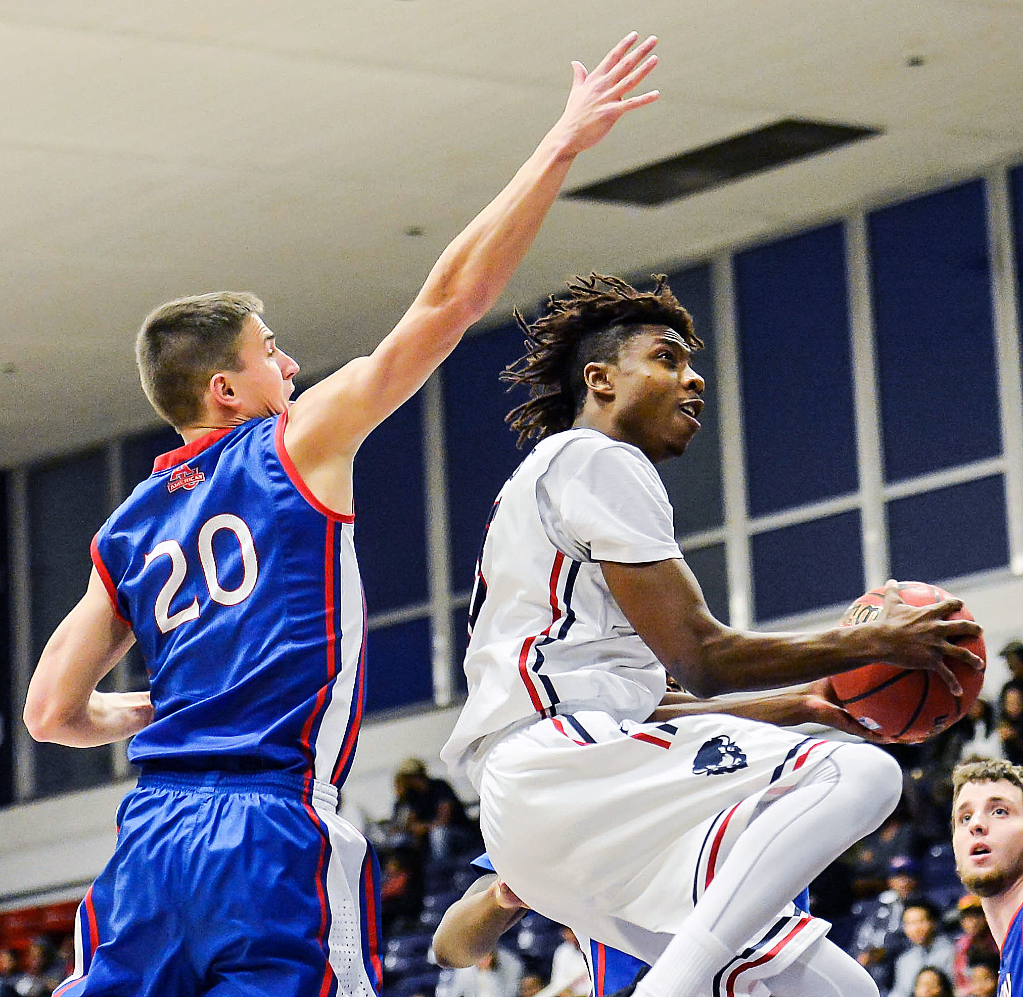 Howard Bison guard Damon Collins sails past American University Eagles guard Charlie Jones in the first half of Howard's 71-54 win at Burr Gymnasium in Northwest on Saturday, Dec. 3. /Photo of courtesy Abdullah Yusuf