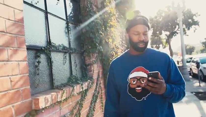 Former NBA superstar Baron Davis wears a sweater bearing his company's Black Santa logo.