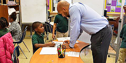 Brandon Johnson assists some of his students at Browne Educational Campus in Northeast. /Courtesy of DCPS via Facebook