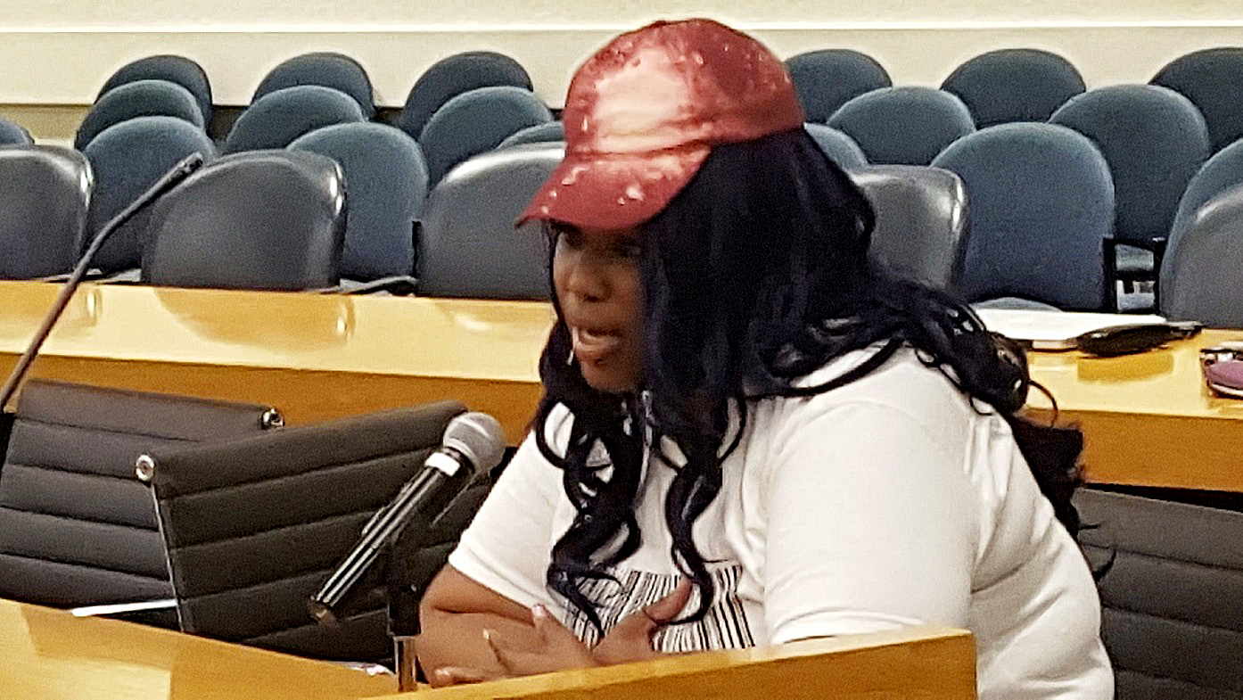 Chauniece Jones of Largo, Maryland, testifies at an Oct. 20 public hearing on Metro's proposal to permanently cut hours of operation at its train stations. /Photo by William J. Ford