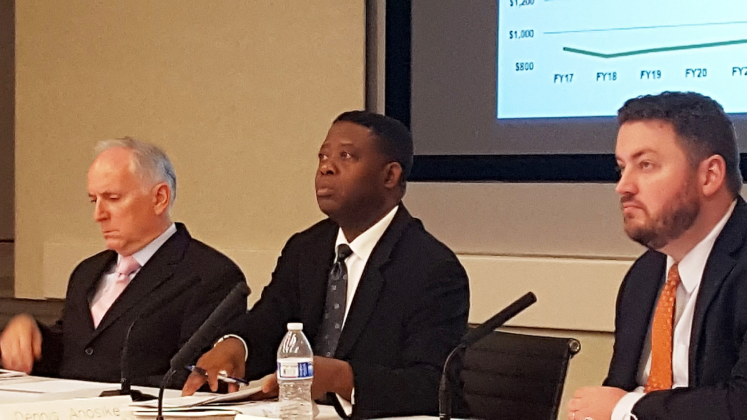 Metro Chief Financial Officer Dennis Anosike (center) briefs the agency's finance committee on Oct. 13 about its $275 million budget shortfall. /Photo by William J. Ford