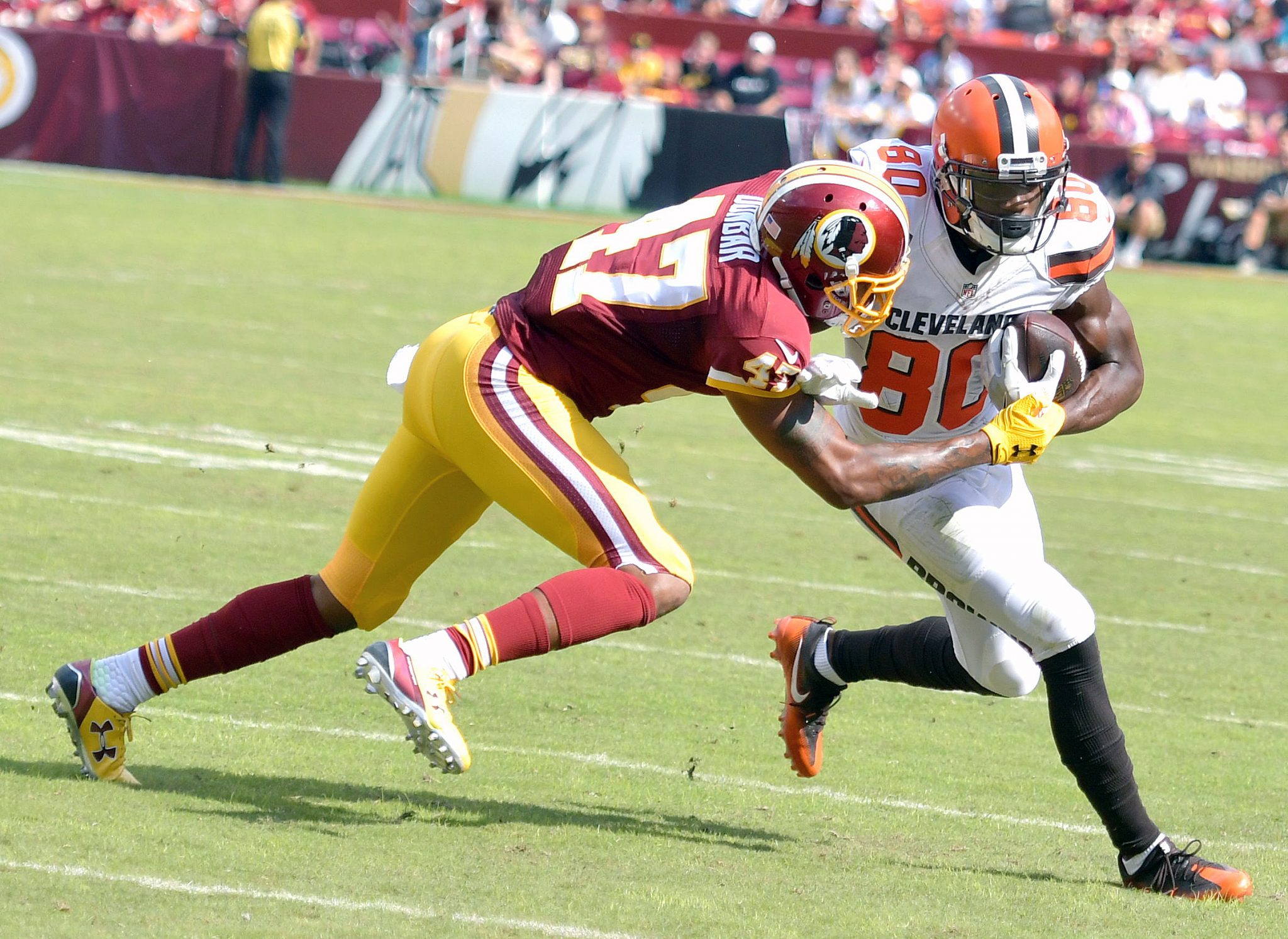 Washington Redskins cornerback Quinton Dunbar tackles Cleveland Browns wide receiver Ricardo Louis during the Redskins' 31-20 win at FedEx Field in Landover, Maryland, on Sunday, Oct. 2. /Photo by John E. De Freitas