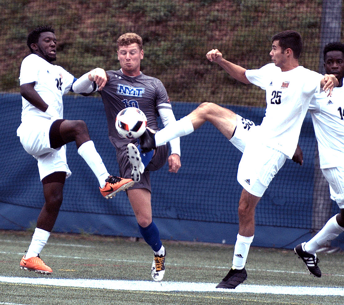 New York Institute of Technology defender Ben Wilson battles with University of the District of Columbia midfielders during a matchup at Georgetown University's Cooper Field in northwest D.C. on Saturday, Oct. 1. NYIT defeated UDC 3-0. /Photo by John E. De Freitas
