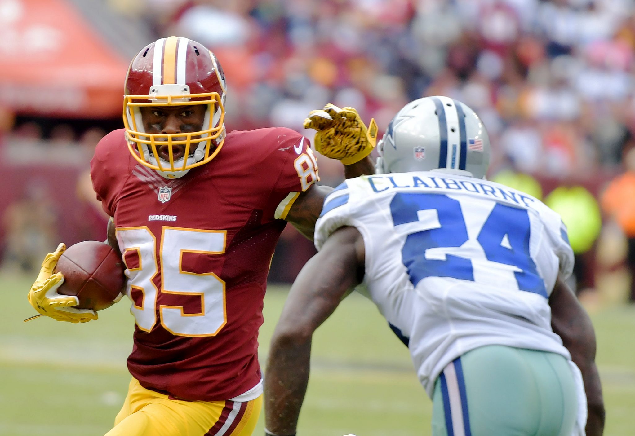 Washington Redskins tight end Vernon Davis stiff-arms Dallas Cowboys cornerback Morris Claiborne after making a reception during the Cowboys' 27-23 win at FedEx Field in Landover, Maryland, on Sunday, Sept. 18. /Photo by John E. De Freitas