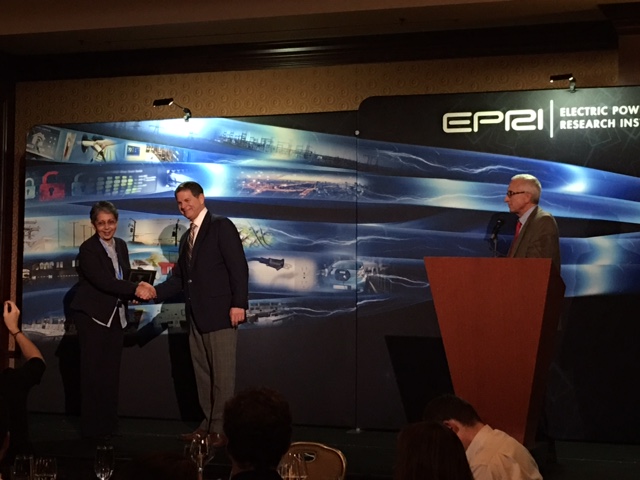 Barbara Gonzales (left) receives an award for applying methodologies and standards to design and deploy EV charging infrastructure. (Courtesy of Pepco Holdings)