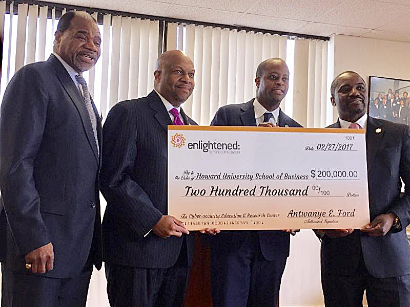 Barron Harvey, dean of Howard University School of Business, Antwanye Ford, president and CEO of Enlightened Inc., Howard President Wayne A.I. Frederick and Andre Rogers, executive vice president/CFO of Enlightened Inc., celebrate a $200,000 gift from Enlightened to Howard's business school on March 9. (Courtesy of Enlightened Inc.)