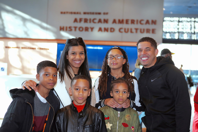 Erin Martin, interim program director of the Boys and Girls Club's FBR branch, poses with club members at the African American History Museum while on the 2017 Washington Informer Heritage Tour. (Demetrious Kinney)