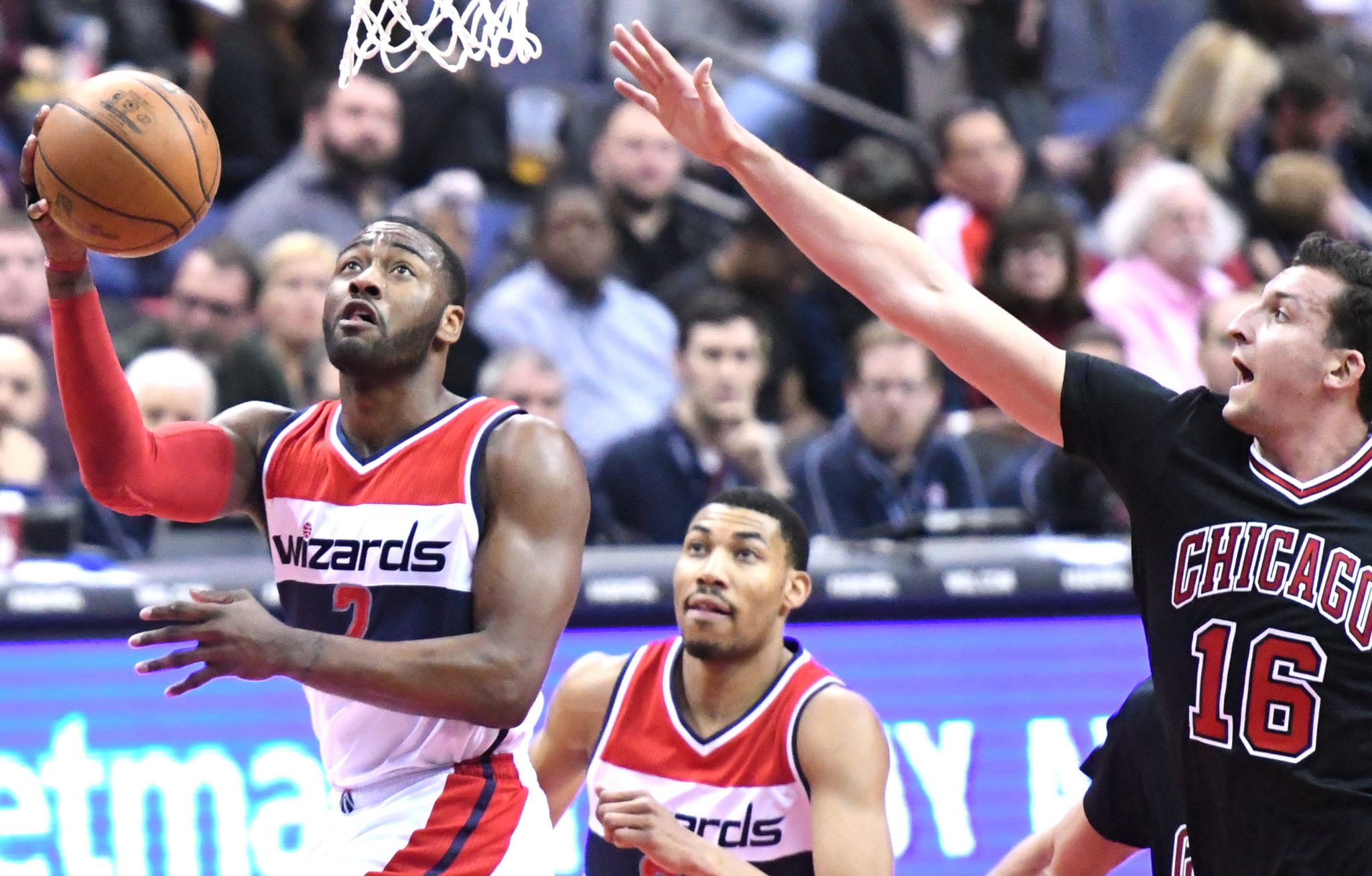 Washington Wizards guard John Wall drives to the basket beyond the outstretched arm of Chicago Bulls forward Paul Zipser in the third quarter of the Wizards' 112-107 win at Verizon Center in D.C. on March 17. (John De Freitas/The Washington Informer)