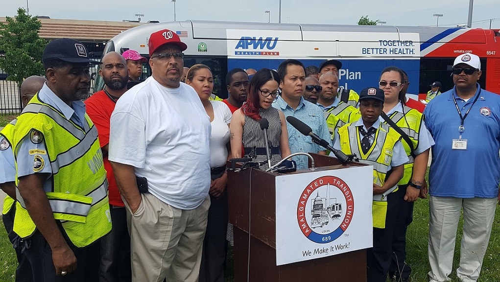 Tracy Smith (at podium), a shop steward and executive board member with Amalgamated Transit Union Local 689, discusses lack of safety on Metro buses during a May 18 press conference outside the Shepherd Parkway Metrobus Division in southwest D.C. (William J. Ford/The Washington Informer)