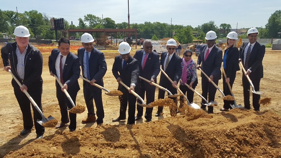 Prince George's County Executive Rushern L. Baker III (fifth from left), site owner Mani Patel (fourth from left) and others dig dirt as part of groundbreaking ceremony for a $50 million retail development in Brandywine on May 10. (William J. Ford/The Washington Informer)