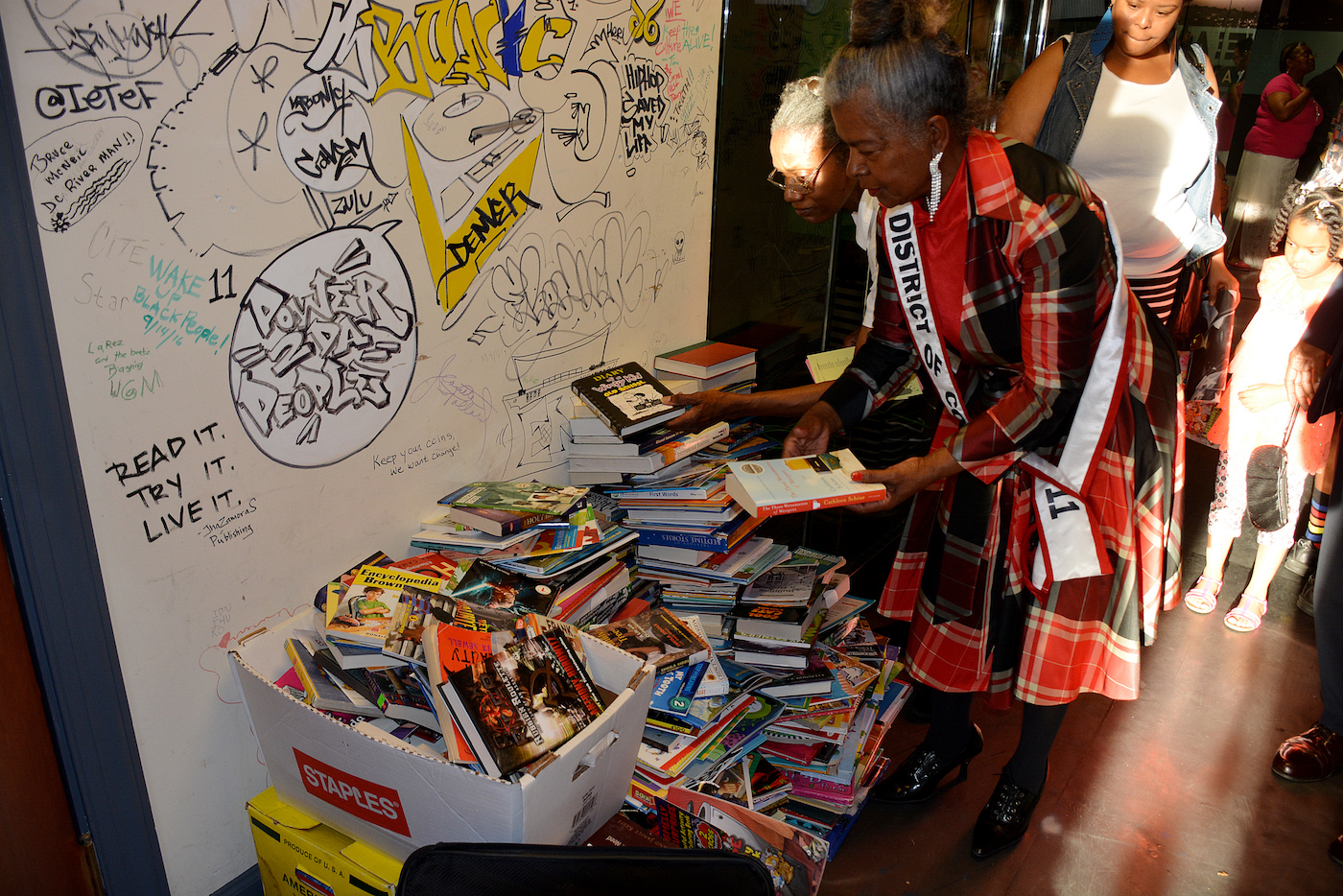 Ms. Senior District of Columbia Emma P. Ward donates books to the new Charnice Milton Community Bookstore in Southeast on May 17. (Roy Lewis/The Washington Informer)