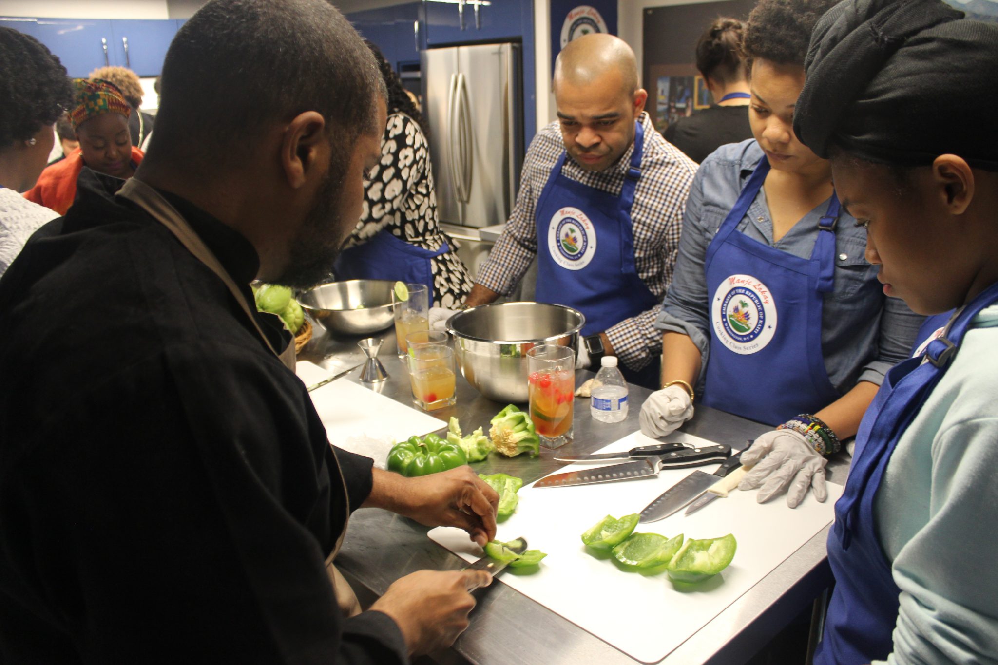 Chef Dimitri Lilavois instructs participants in cooking techniques. (Imani Cezanne/Busboys and Poets)