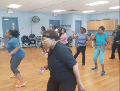 Tyra L. Pointer (left) leads a weekly Zumba class at the Camp Springs Senior Activity Center on May 19, with the participants being at least 60 years old. (William J. Ford/The Washington Informer)