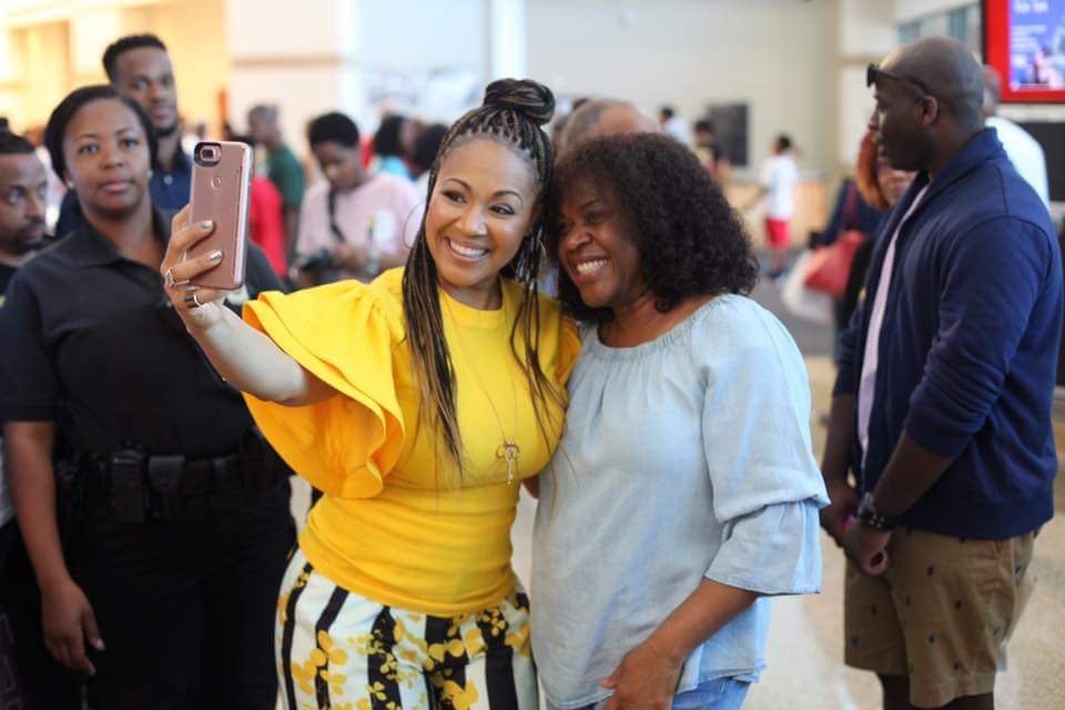 Gospel recording artist Erica Campbell (in yellow) takes a photo with Lady Trina Jenkins at the First Baptist Church of Glenarden's annual Health and Wellness Expo in Upper Marlboro, Maryland, on June 10. (Courtesy of First Baptist Church via Facebook)
