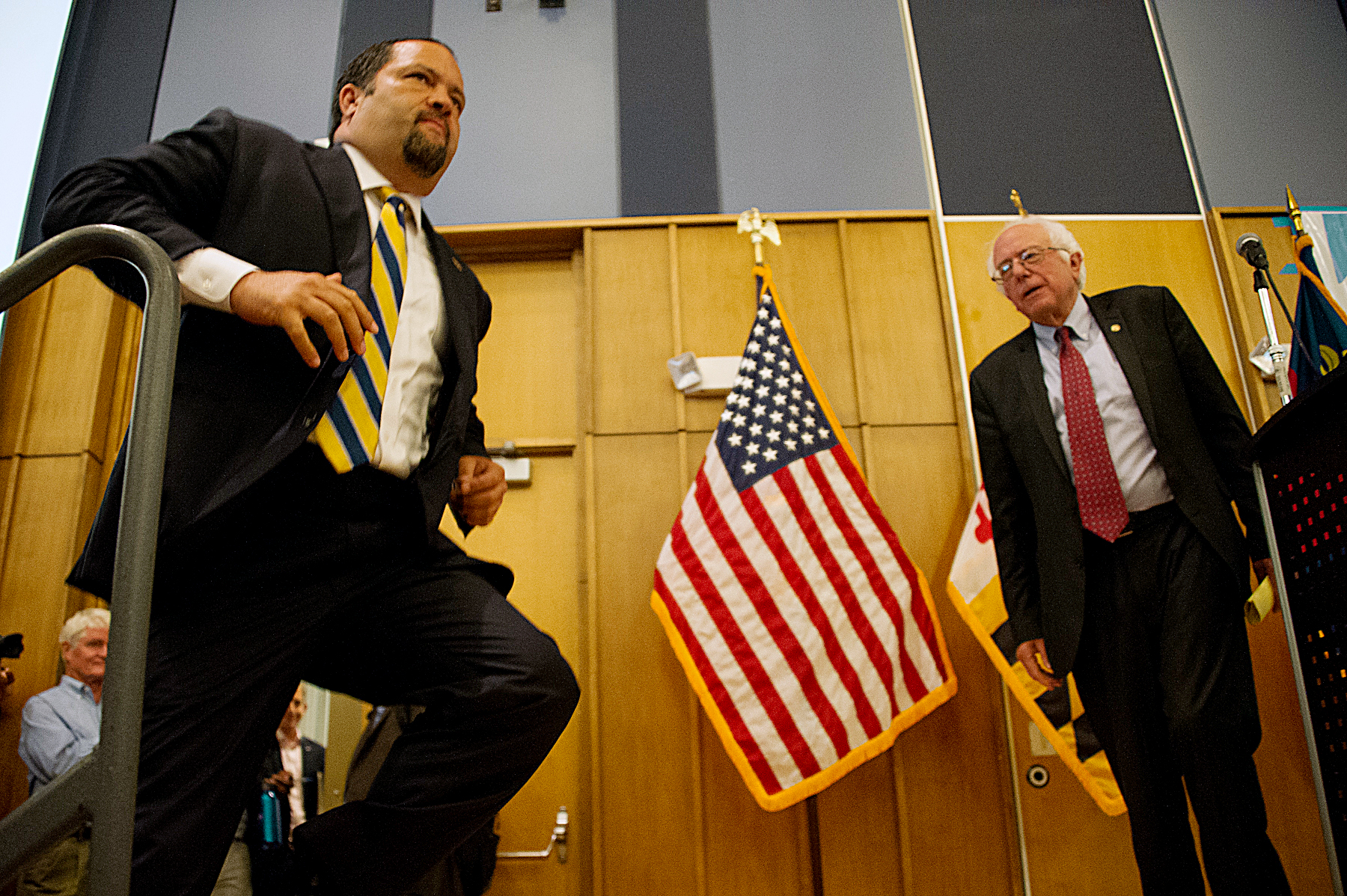 Ben Jealous, a Democratic candidate for Maryland governor, jumps onstage after a rousing introduction on July 14 in Silver Spring, Md., by former presidential candidate, Sen. Bernie Sanders. (Lateef Mangum/The Washington Informer)