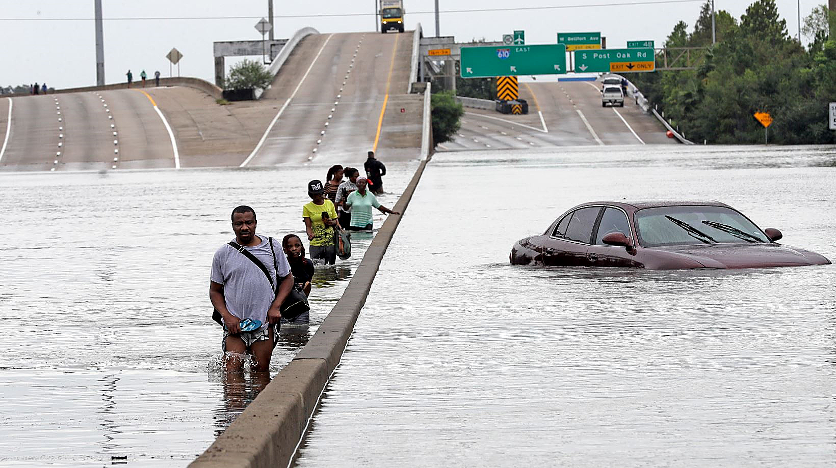 Residents of Houston walk along a major artery of the city as the waters from Tropical Storm Harvey continue to batter portions of the Gulf Coast region. (Courtesy photo)