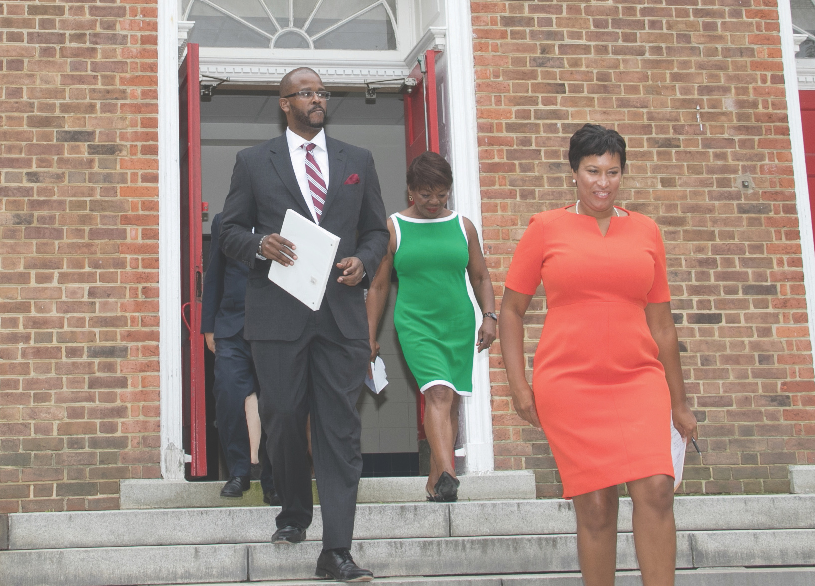 D.C. Mayor Muriel Bowser (right), Public Schools Chancellor Antwan Wilson (left) and Washington Teachers Union President Elizabeth Davis announce a tentative agreement for a new contract at Bunker Hill Elementary School in Northeast on Aug. 14. (Shevry Lassiter/The Washington Informer)