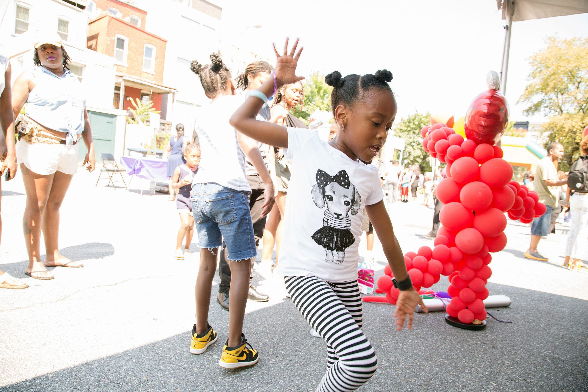 D.C. resident Samuela Griffiths dances in front of a small audience during a back-to-school festival at the Thurgood Marshall Center in northwest D.C. on Aug. 19. (Mark Mahoney/The Washington Informer)