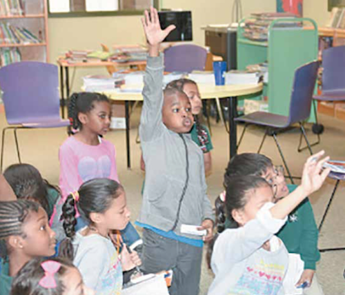 Eager schoolchildren participate in classroom activities. (Courtesy of DCPS)