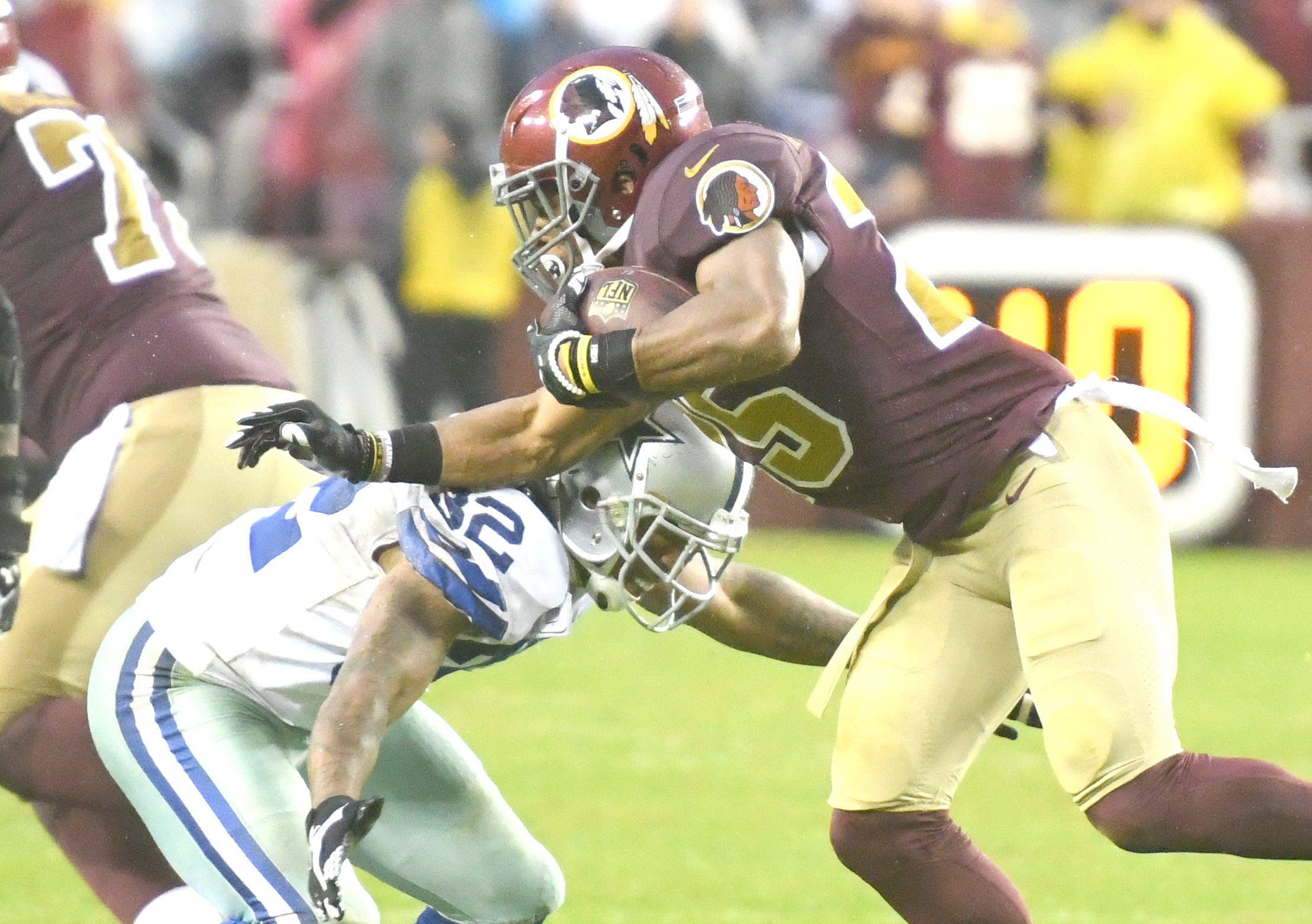Dallas Cowboys cornerback Orlando Scandrick tackles Washington Redskins running back Chris Thompson during Dallas' 33-19 win at FedEx Field in Landover, Md., on Oct. 29. (John E. De Freitas/The Washington Informer)