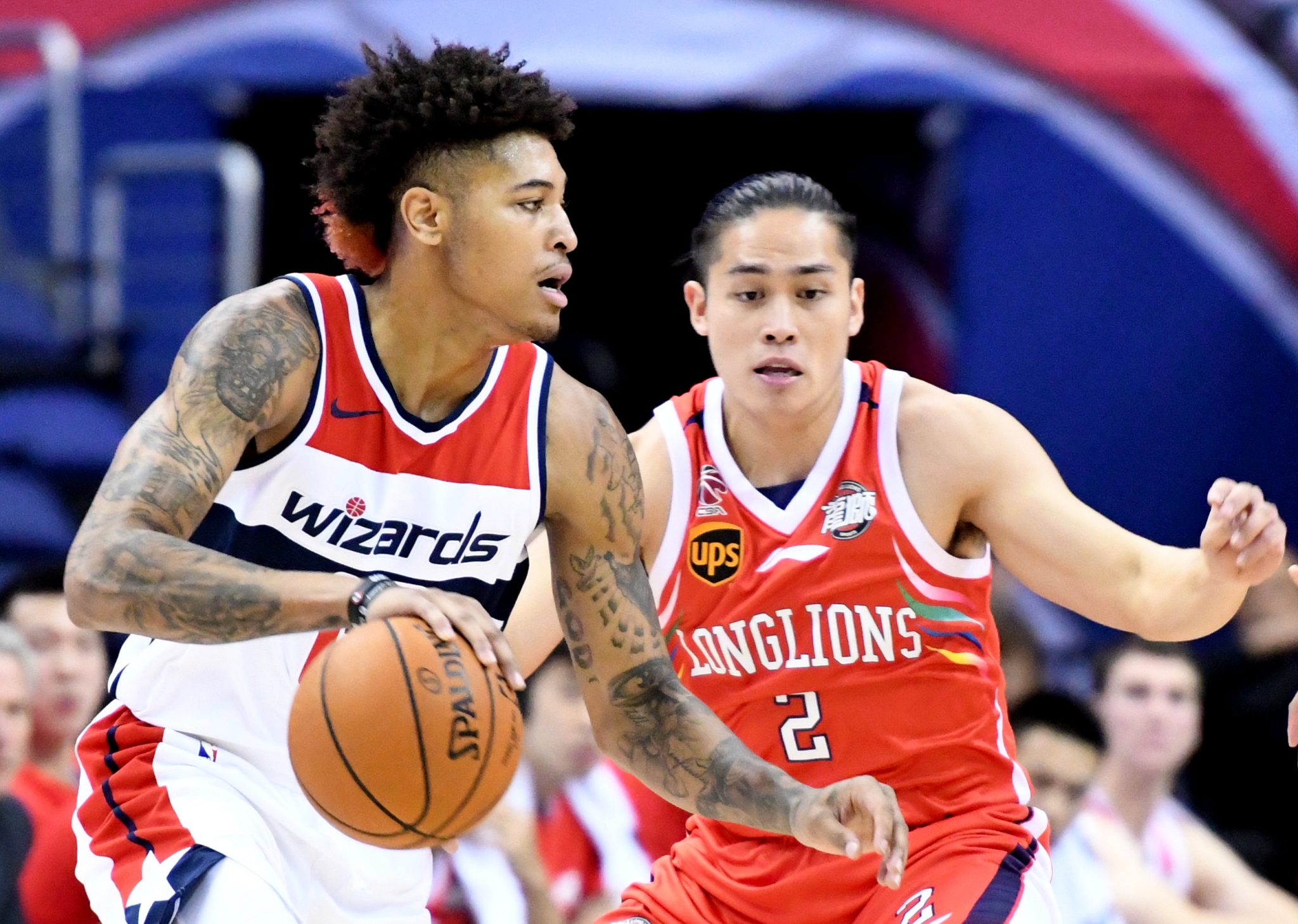 Washington Wizards forward Kelly Oubre Jr. drives past Guangzhou Long-Lions' Chen Yingjun in the first quarter of the Wizards' 126-96 win at Capital One Arena in northwest D.C. on Oct 2. (John E. De Freitas/The Washington Informer)