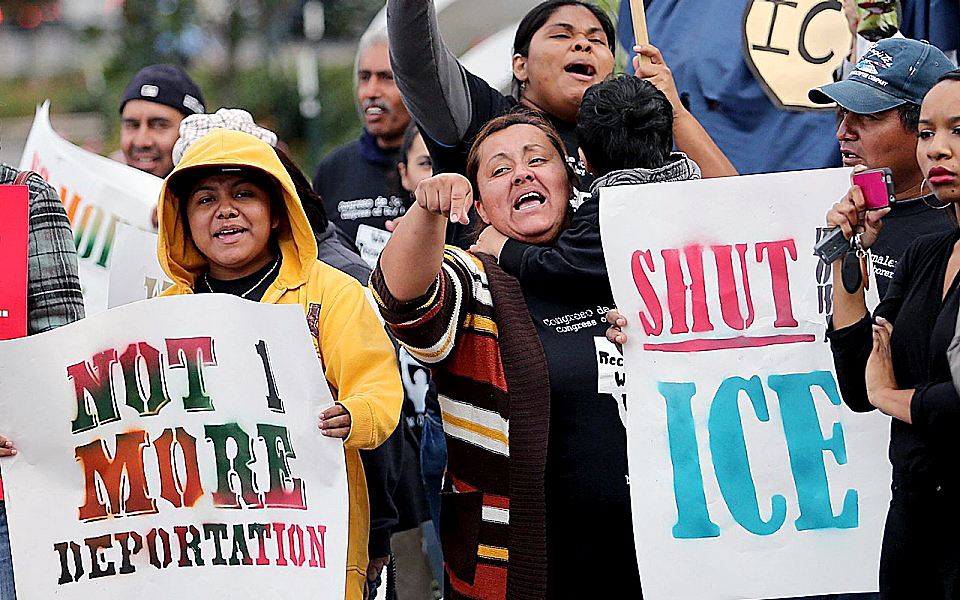 Demonstrators protest against ICE raids. (Courtesy of Al Jazeera America)