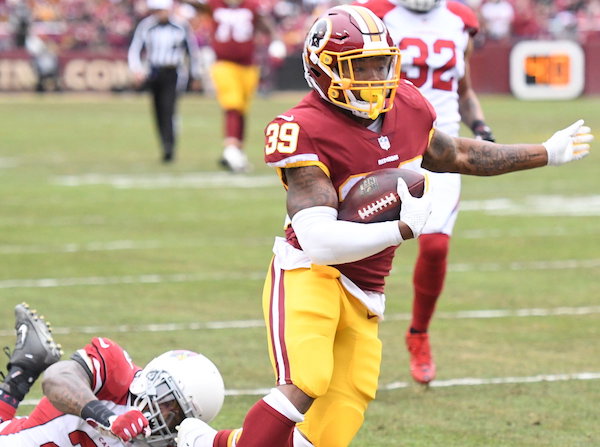Washington Redskins running back Kapri Bibbs breaks a tackle by Arizona Cardinals linebacker Deone Bucannon to score a touchdown during the Redskins' 20-15 win at FedEx Field in Landover, Maryland, on Dec.17. (John E. De Freitas/The Washington Informer)