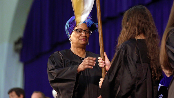 Mélisande Short-Colomb takes the Georgetown College banner as she becomes a member of the Class of 2021 during a convocation ceremony on Aug. 27. (Courtesy of Georgetown University)