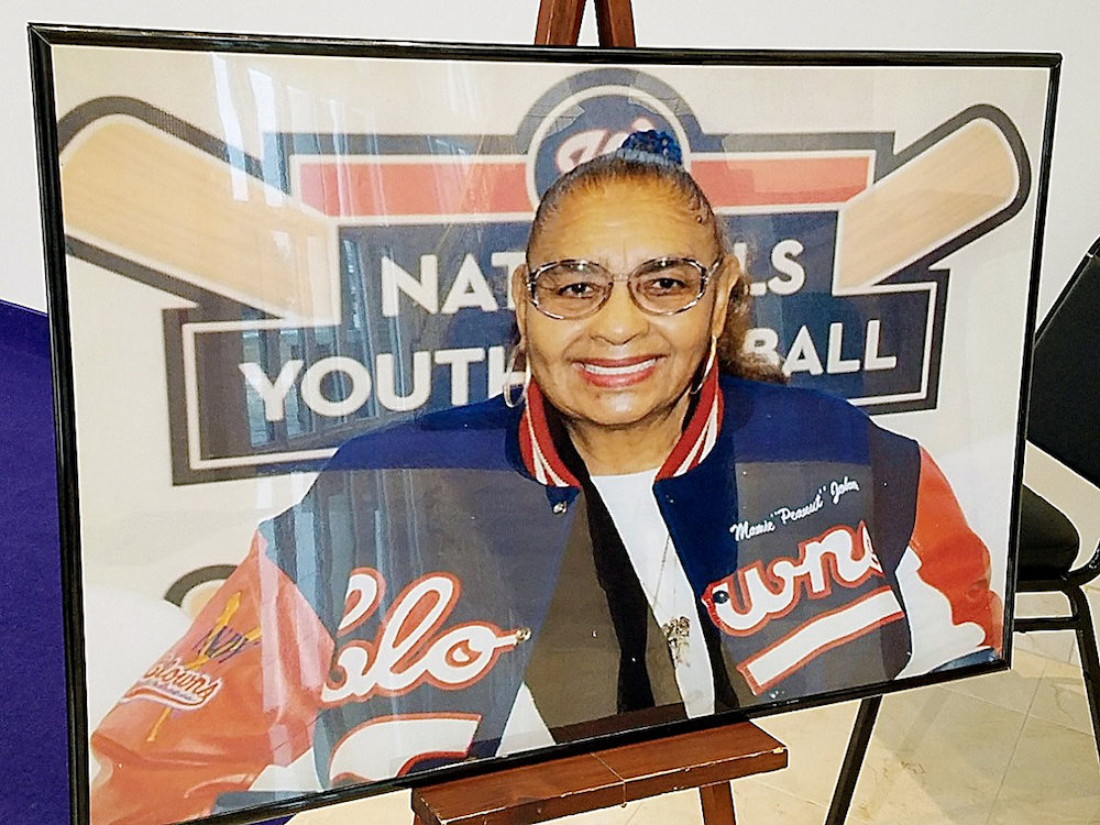 A portrait of Mamie "Peanut" Johnson sits on an easel for family and friends to view outside the sanctuary at Way of the Cross Church of Christ in Capitol Heights during a Dec. 30 memorial service. (William J. Ford/The Washington Informer)