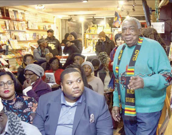 A. Peter Bailey (far right) moves to address the audience during the screening of "Malcolm X: An Overwhelming Influence on America's Black Power Movement" at Sankofa Video Books & Cafe in northwest D.C. on Jan. 3. (E Watson/EDI Photo)