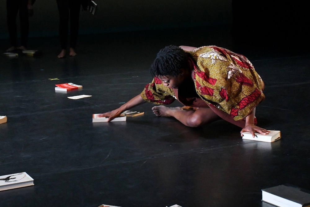 Ronya-Lee Anderson stretches on the floor to perform a piece she created called "Canon" during a dress rehearsal at the Clarice Smith Performing Arts Center in College Park on Jan. 26. (Roy Lewis/The Washington Informer)