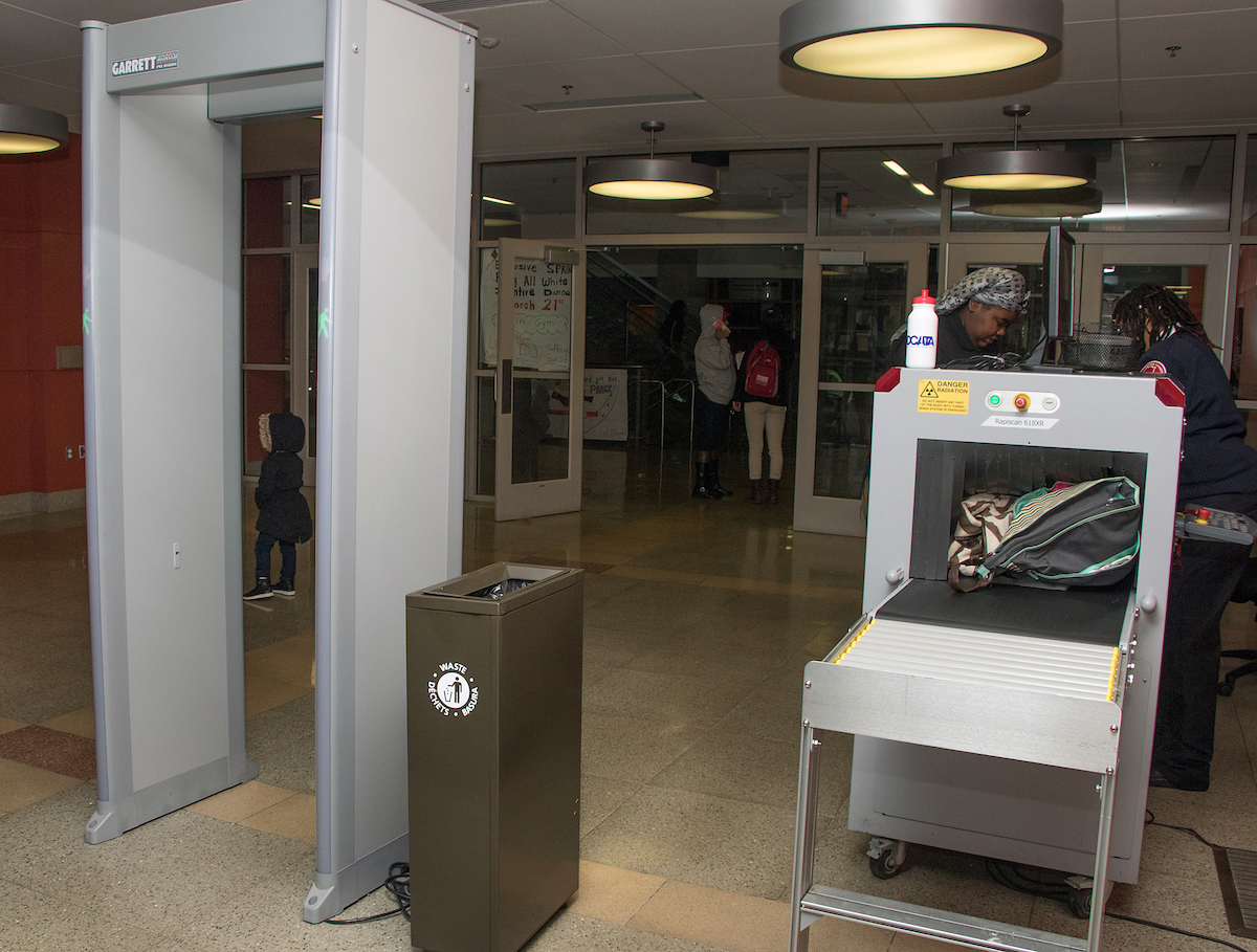 The first line of security at most high schools in the District of Columbia are metal detectors and screening devices like those shown here at H.D. Woodson High School in Northeast staffed by security personnel. (Shevry Lassiter/The Washington Informer)