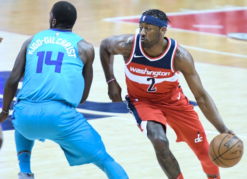 Washington Wizards guard John Wall attempts a layup as Charlotte Hornets guard Kemba Walker looks on during the Wizards' 107-93 win in D.C. on March 31. (John De Freitas/The Washington Informer)