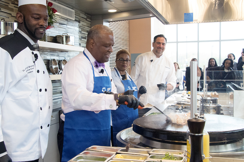 The Prince George’s County Community College Culinary Arts Center Chef Edward Whitfield, County Executive Rushern L. Baker III, Prince George’s Community College President Charlene Dukes and MGM National Harbor Executive Chef Jason Johnston prepare a meal in the kitchen of the new center during the grand opening on April 19. (Shevry Lassiter/The Washington Informer)