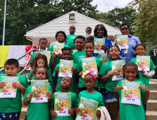 D.C. People's Counsel Sandra Mattavous-Frye and Community Outreach Specialist Denise Blackson pose with children attending an OPC energy efficiency workshop at Upshur Recreation Center in northwest D.C. as part of OPC's partnership with the D.C. Department of Parks and Recreation.