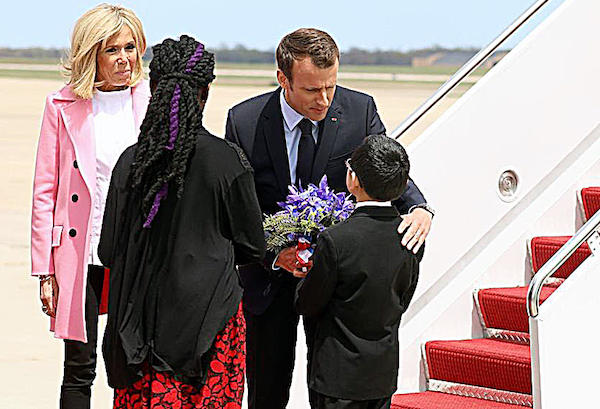 French President Emmanuel Macron and his wife Brigitte greet fourth-graders Owen Sze (right) and Marissa Tyler after exiting a plane at Joint Base Andrews. The two students were among the first people to greet Macron and his wife upon their visit to the U.S. in April. (Courtesy of the Embassy of France in the U.S.)